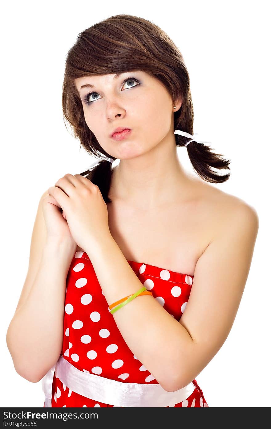 Young pretty girl in dot polka dress on white background