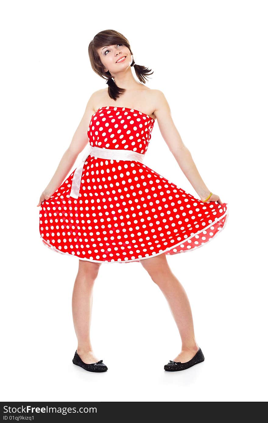 Young pretty girl in dot polka dress on white background