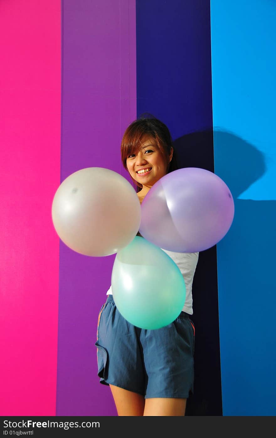 Young Asian Woman Holding Balloons