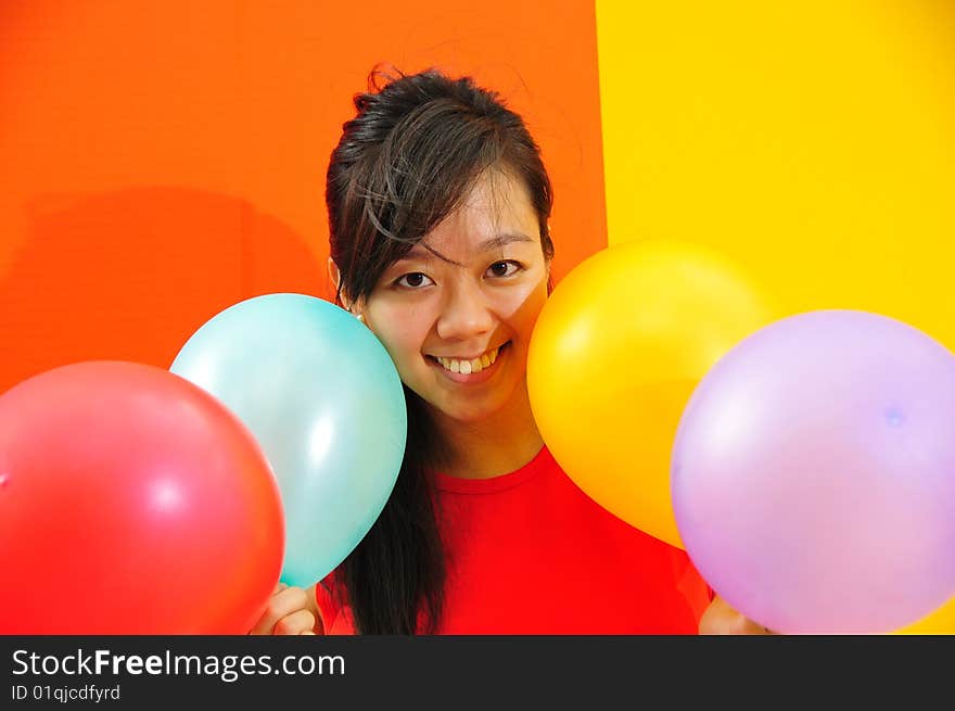 Young Asian Woman Holding Balloons