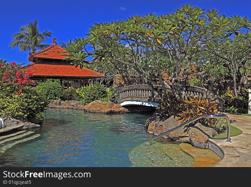 Beautiful swimming pool with early morning sun in the tropics.