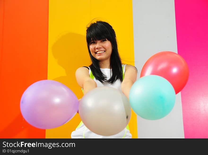 Young Asian Woman Holding Balloons