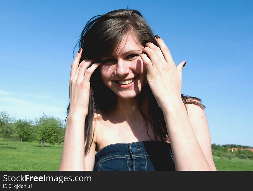 Girl smiles and corrects hair