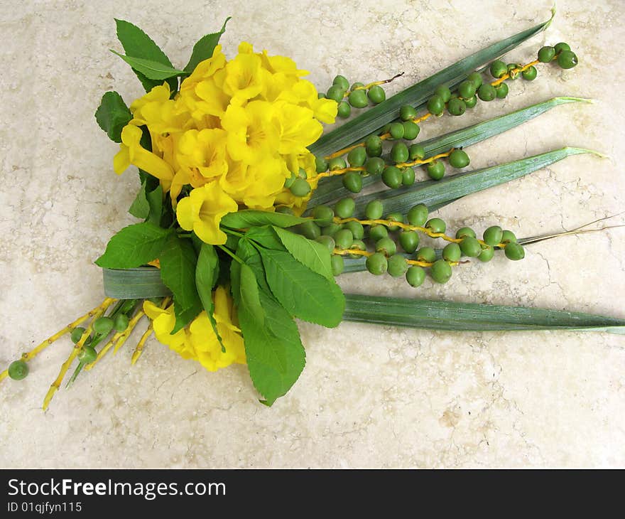 Bouquet from leaves of palm  and acacia on marble