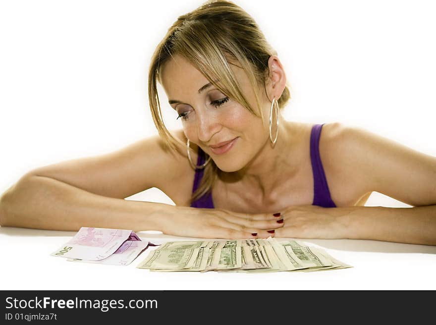 Woman leaning on a table looking at some cash. Woman leaning on a table looking at some cash