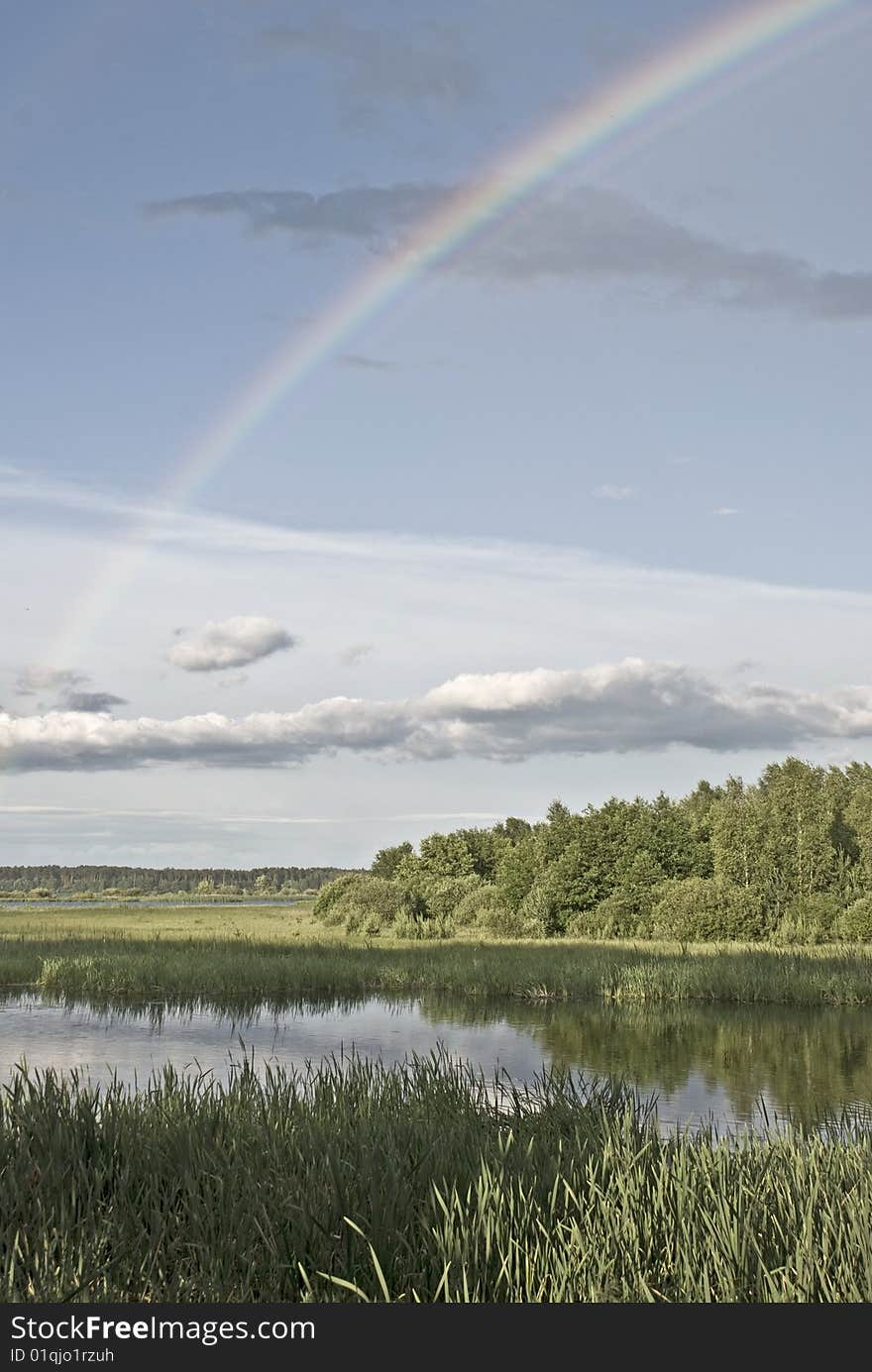 Rainbow over the lake landscape. Rainbow over the lake landscape