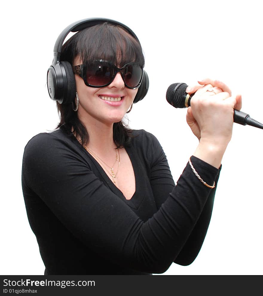 Woman in headphones holding his hands a microphone on a white background. Woman in headphones holding his hands a microphone on a white background