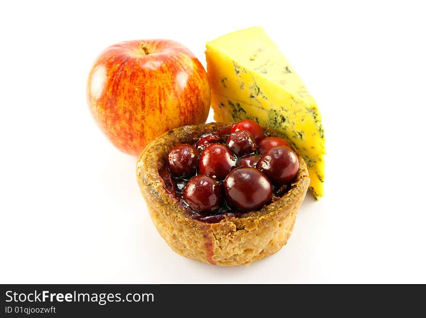 Single pork pie with a slice of blue cheese and an apple with clipping path on a white background. Single pork pie with a slice of blue cheese and an apple with clipping path on a white background