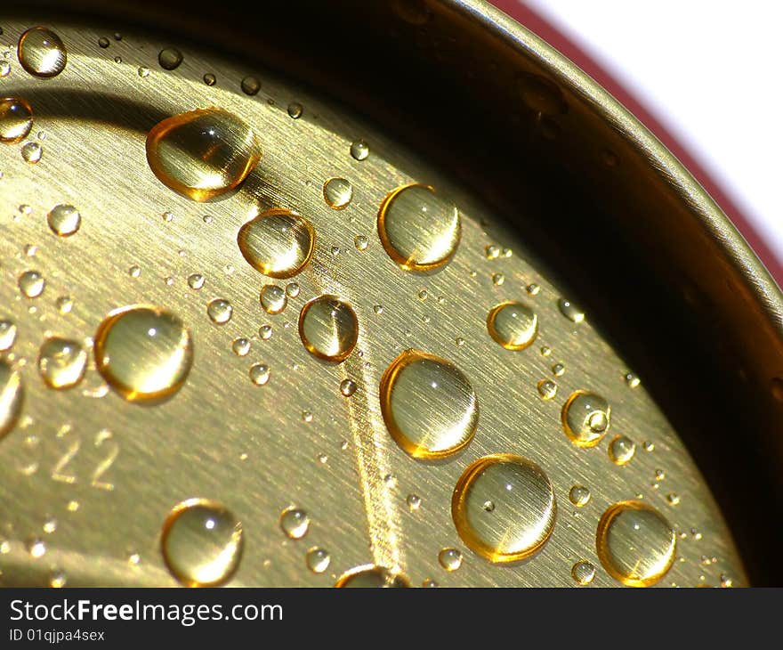 Water drops on gold tin. Water drops on gold tin