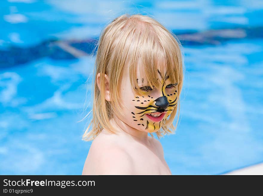 Girl with paint on his face in the pool. Girl with paint on his face in the pool