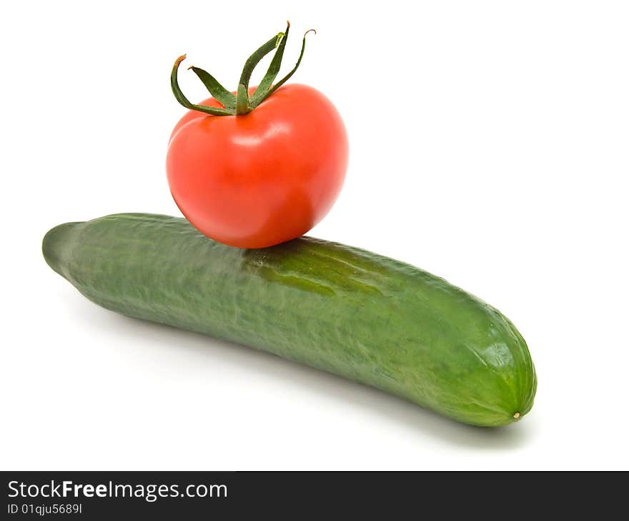 Cucumber and red tomato isolated on white background.