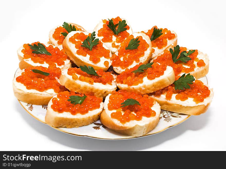 Red caviar on white bread, parsley on top. Red caviar on white bread, parsley on top