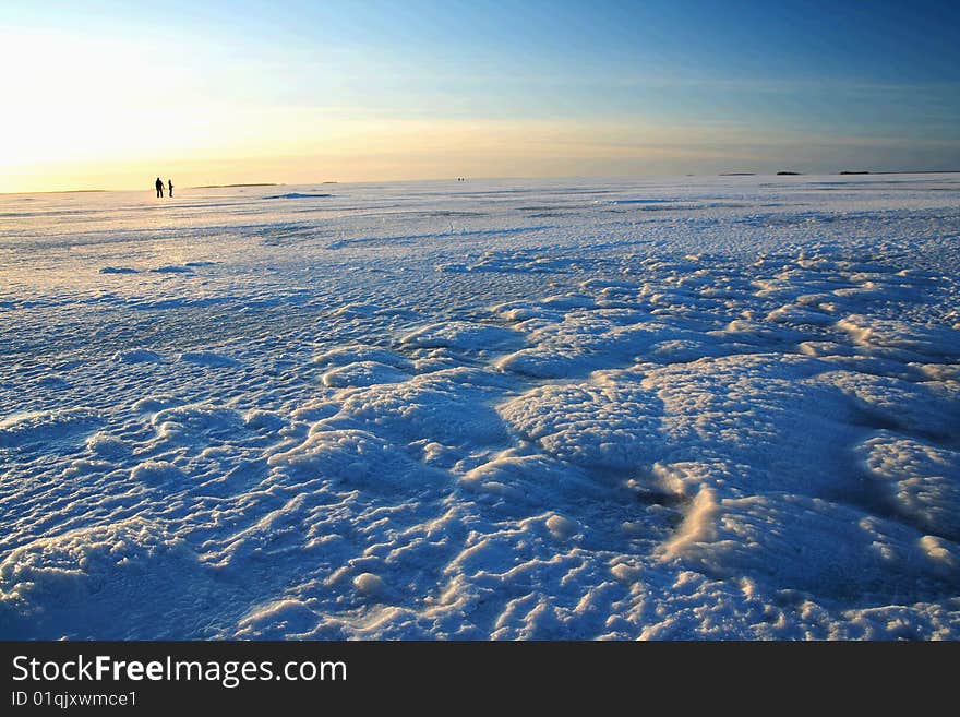 Sunset over frozen lake