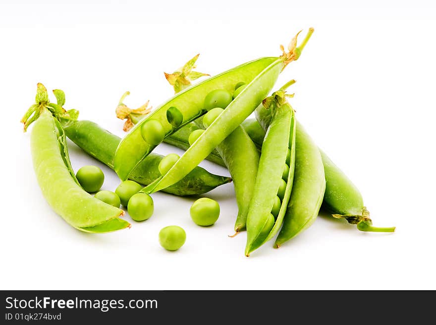 Pods of fresh green peas on a white background