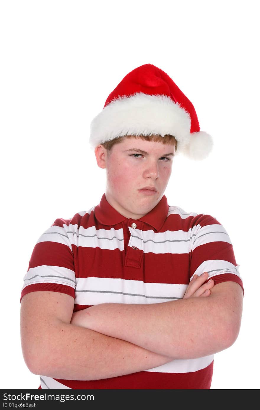 Teenage boy in santa hat with arms crossed. Teenage boy in santa hat with arms crossed