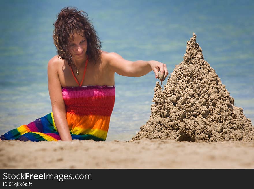 A woman building a sandcastle