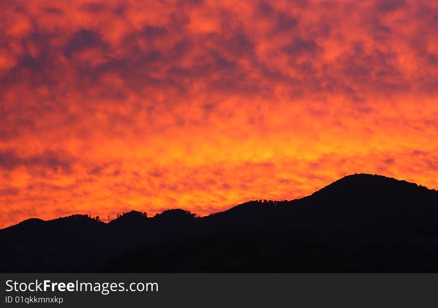 Rising sun and silhouette of mountains