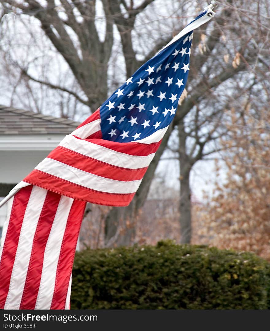 An American flag flying in a mid west USA neighborhood. An American flag flying in a mid west USA neighborhood.