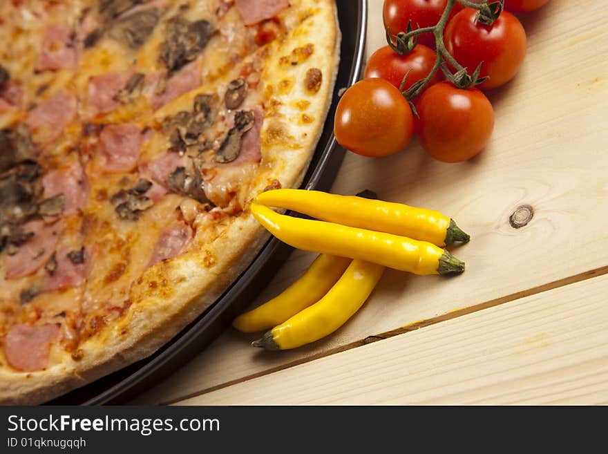 A couple of delicious pizzas, with raw tomatoes, green peppers and mushrooms. A couple of delicious pizzas, with raw tomatoes, green peppers and mushrooms