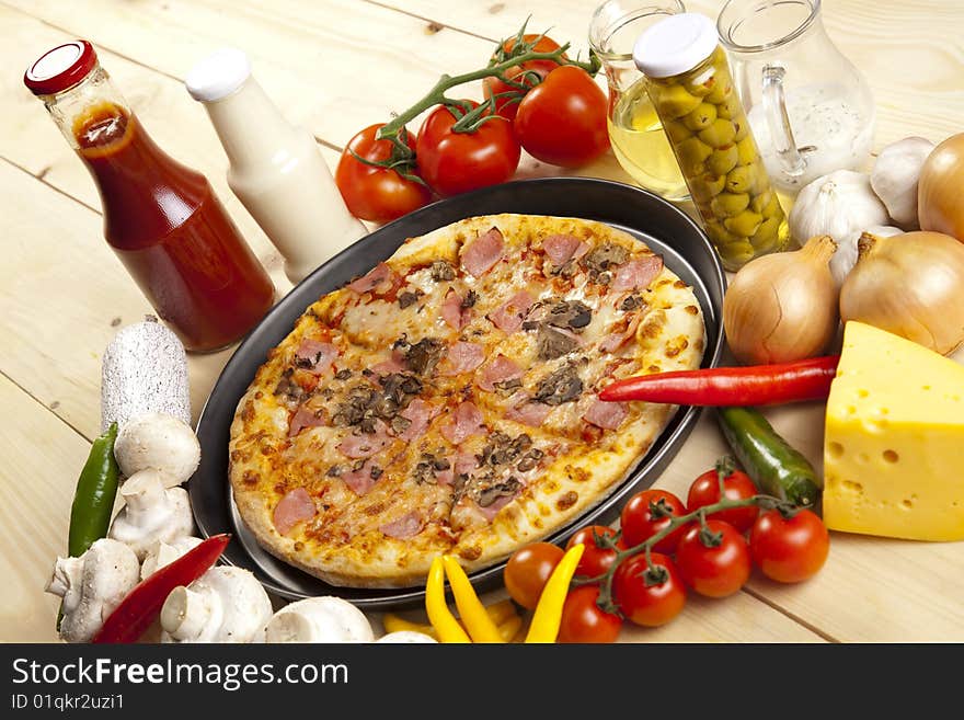 A couple of delicious pizzas, with raw tomatoes, green peppers and mushrooms. A couple of delicious pizzas, with raw tomatoes, green peppers and mushrooms