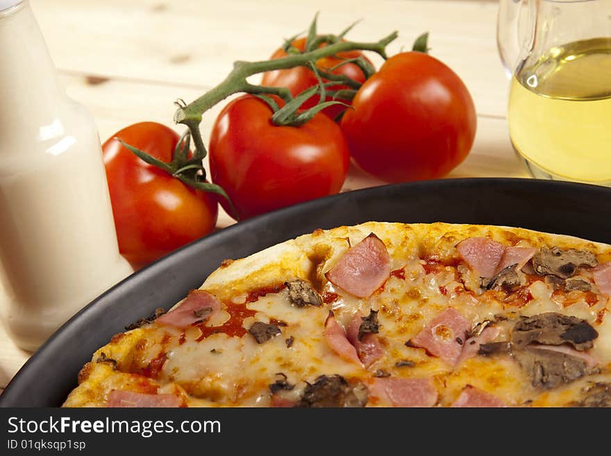 A couple of delicious pizzas, with raw tomatoes, green peppers and mushrooms. A couple of delicious pizzas, with raw tomatoes, green peppers and mushrooms