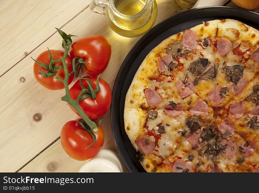 A couple of delicious pizzas, with raw tomatoes, green peppers and mushrooms. A couple of delicious pizzas, with raw tomatoes, green peppers and mushrooms