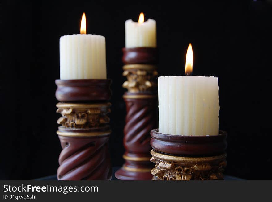 Three candelabra in black background. Three candelabra in black background