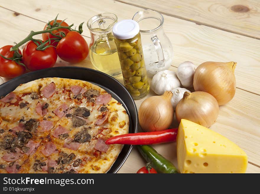 A couple of delicious pizzas, with raw tomatoes, green peppers and mushrooms. A couple of delicious pizzas, with raw tomatoes, green peppers and mushrooms