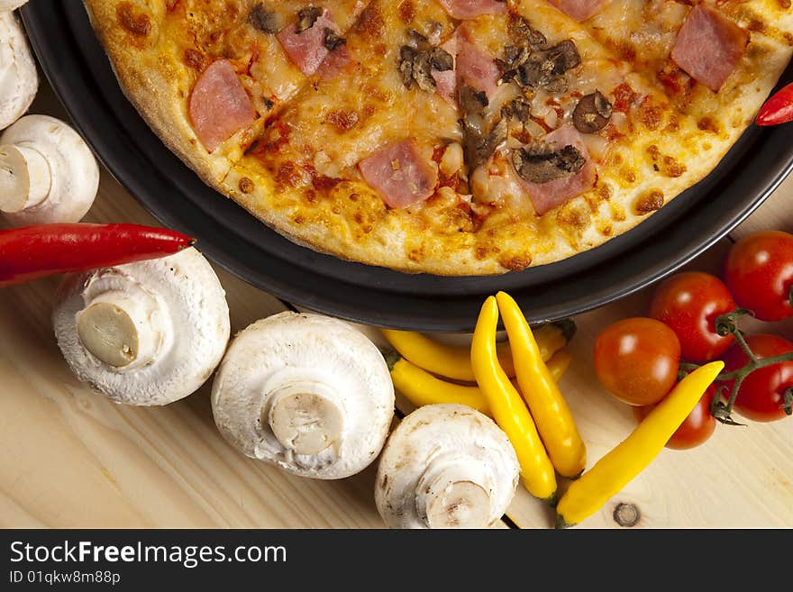 A couple of delicious pizzas, with raw tomatoes, green peppers and mushrooms. A couple of delicious pizzas, with raw tomatoes, green peppers and mushrooms