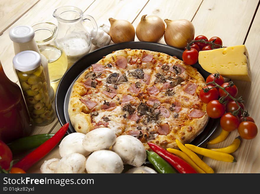 A couple of delicious pizzas, with raw tomatoes, green peppers and mushrooms. A couple of delicious pizzas, with raw tomatoes, green peppers and mushrooms