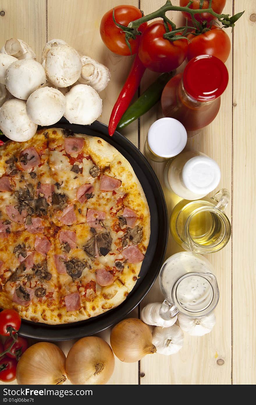 A couple of delicious pizzas, with raw tomatoes, green peppers and mushrooms. A couple of delicious pizzas, with raw tomatoes, green peppers and mushrooms