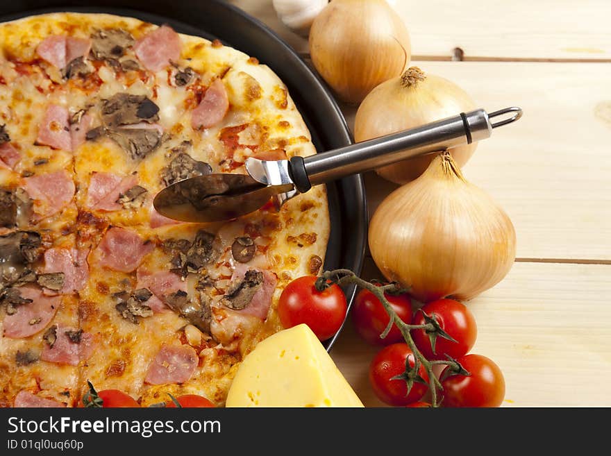 A couple of delicious pizzas, with raw tomatoes, green peppers and mushrooms. A couple of delicious pizzas, with raw tomatoes, green peppers and mushrooms