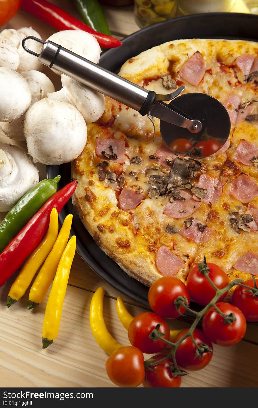 A couple of delicious pizzas, with raw tomatoes, green peppers and mushrooms. A couple of delicious pizzas, with raw tomatoes, green peppers and mushrooms