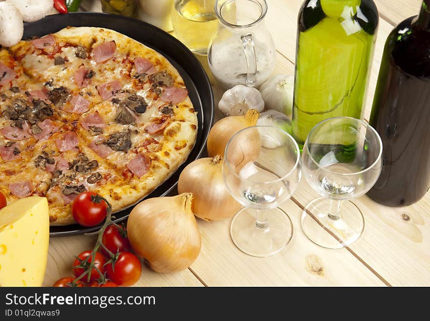 A couple of delicious pizzas, with raw tomatoes, green peppers and mushrooms. A couple of delicious pizzas, with raw tomatoes, green peppers and mushrooms