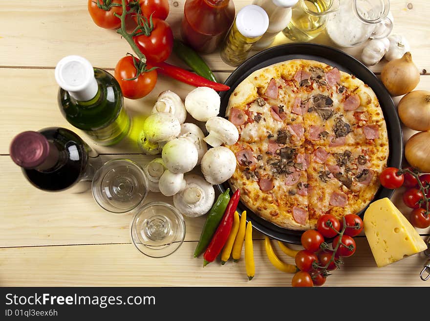 A couple of delicious pizzas, with raw tomatoes, green peppers and mushrooms. A couple of delicious pizzas, with raw tomatoes, green peppers and mushrooms