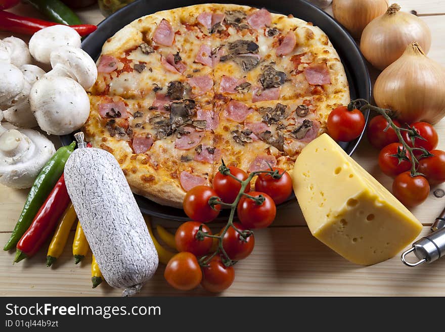 A couple of delicious pizzas, with raw tomatoes, green peppers and mushrooms. A couple of delicious pizzas, with raw tomatoes, green peppers and mushrooms