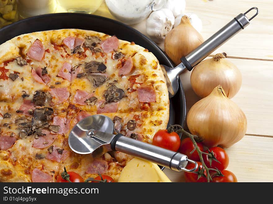 A couple of delicious pizzas, with raw tomatoes, green peppers and mushrooms. A couple of delicious pizzas, with raw tomatoes, green peppers and mushrooms