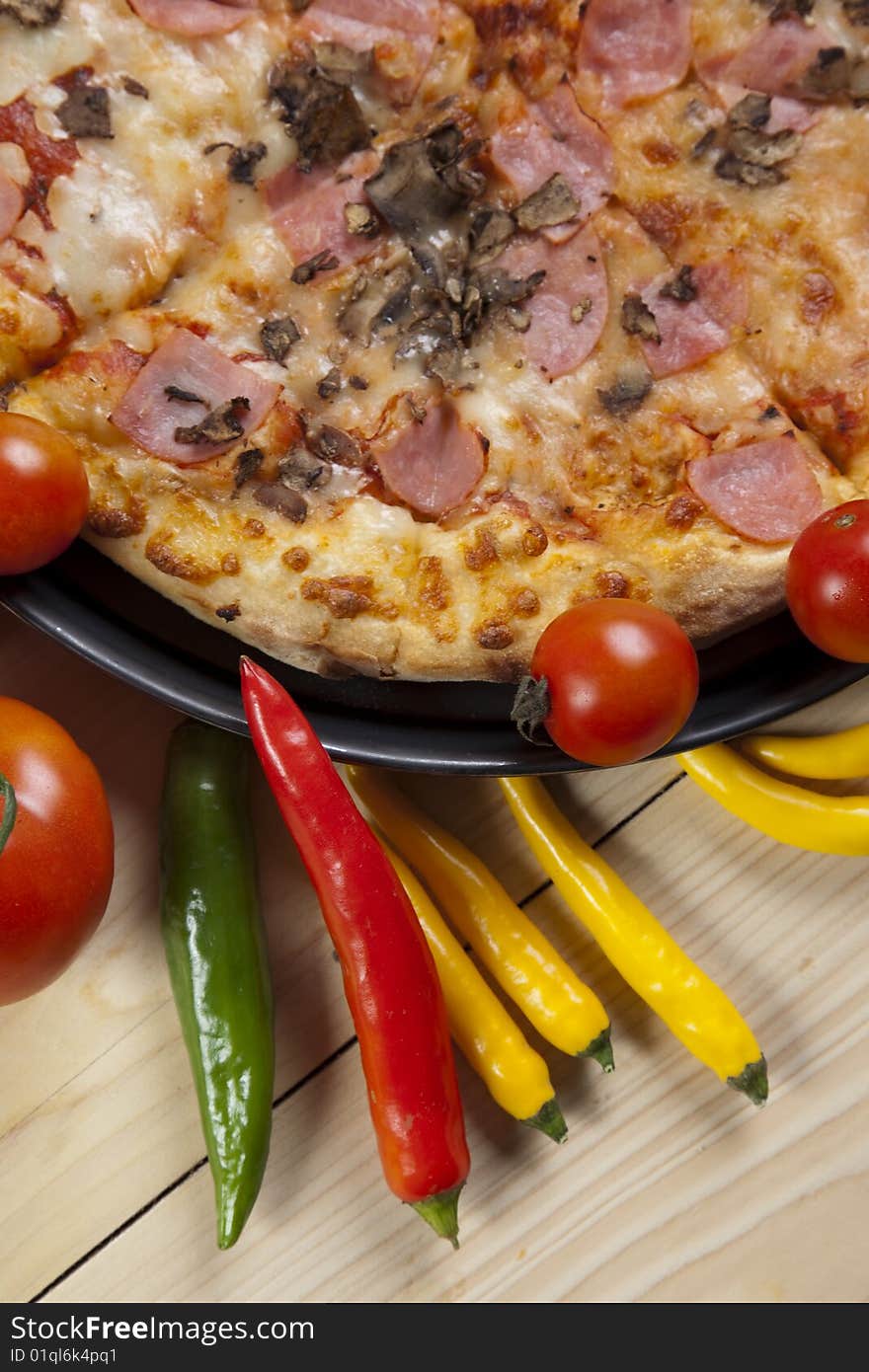 A couple of delicious pizzas, with raw tomatoes, green peppers and mushrooms. A couple of delicious pizzas, with raw tomatoes, green peppers and mushrooms