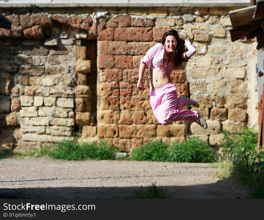 Happy girl jumping on grunge background