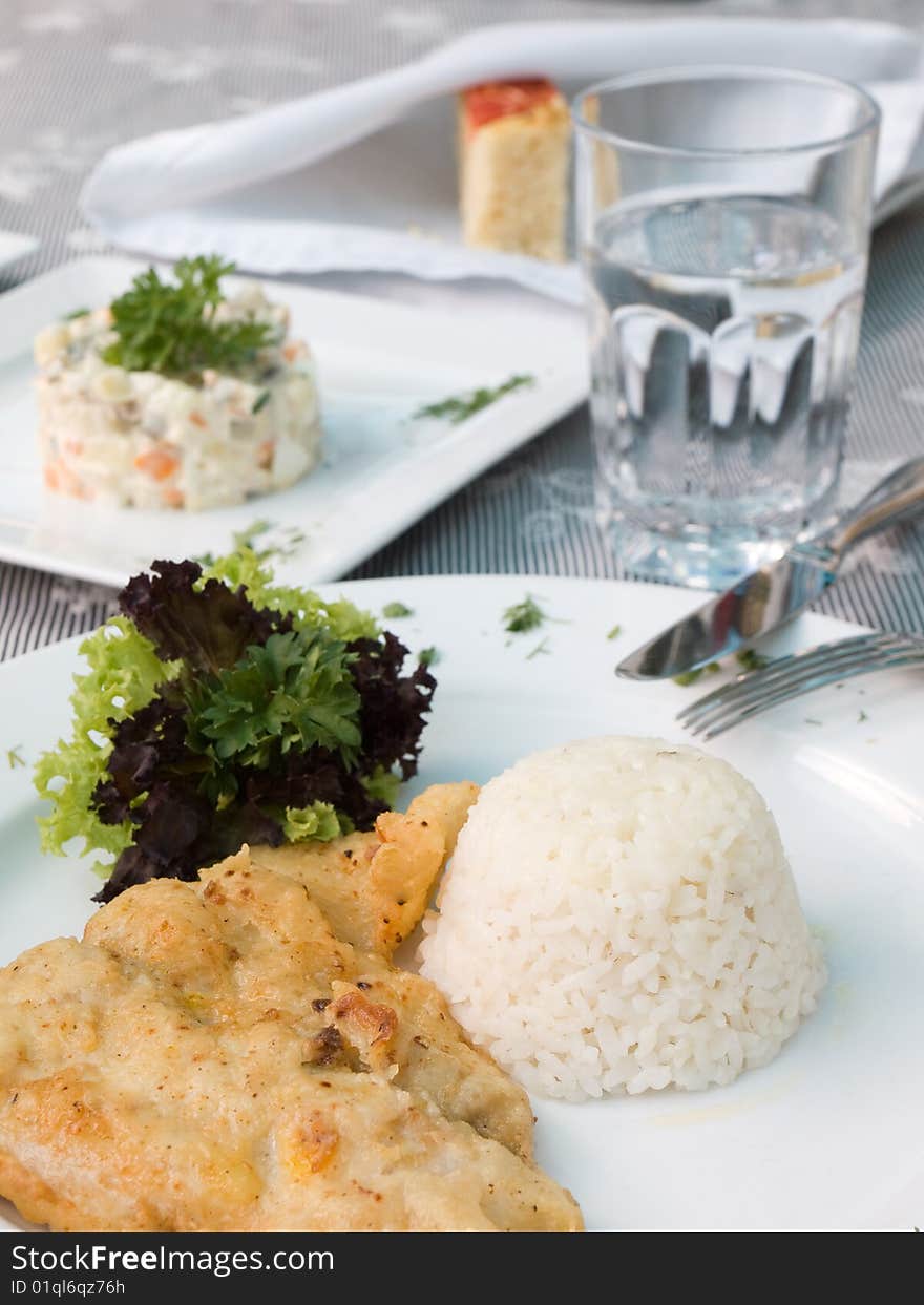 Roasted meat with rice and salad