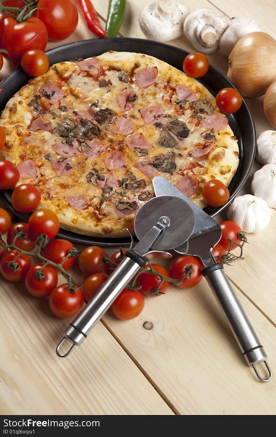 A couple of delicious pizzas, with raw tomatoes, green peppers and mushrooms. A couple of delicious pizzas, with raw tomatoes, green peppers and mushrooms