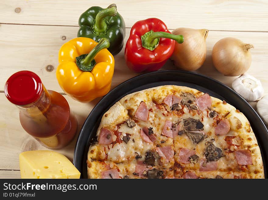 A couple of delicious pizzas, with raw tomatoes, green peppers and mushrooms. A couple of delicious pizzas, with raw tomatoes, green peppers and mushrooms