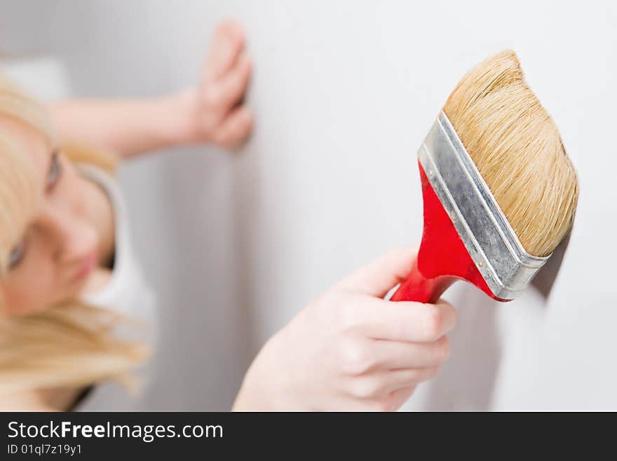 Young beautiful girl with paint brush