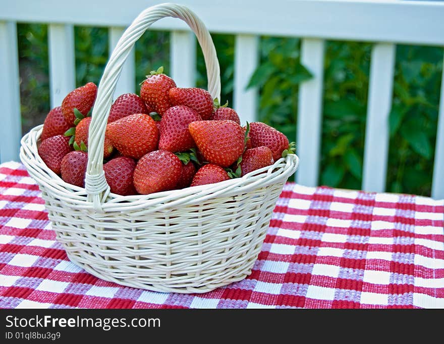 Summer strawberries in a wicker basket. Summer strawberries in a wicker basket.