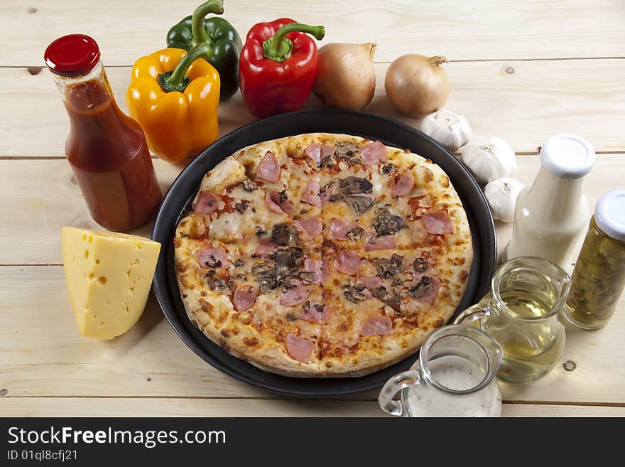 A couple of delicious pizzas, with raw tomatoes, green peppers and mushrooms. A couple of delicious pizzas, with raw tomatoes, green peppers and mushrooms