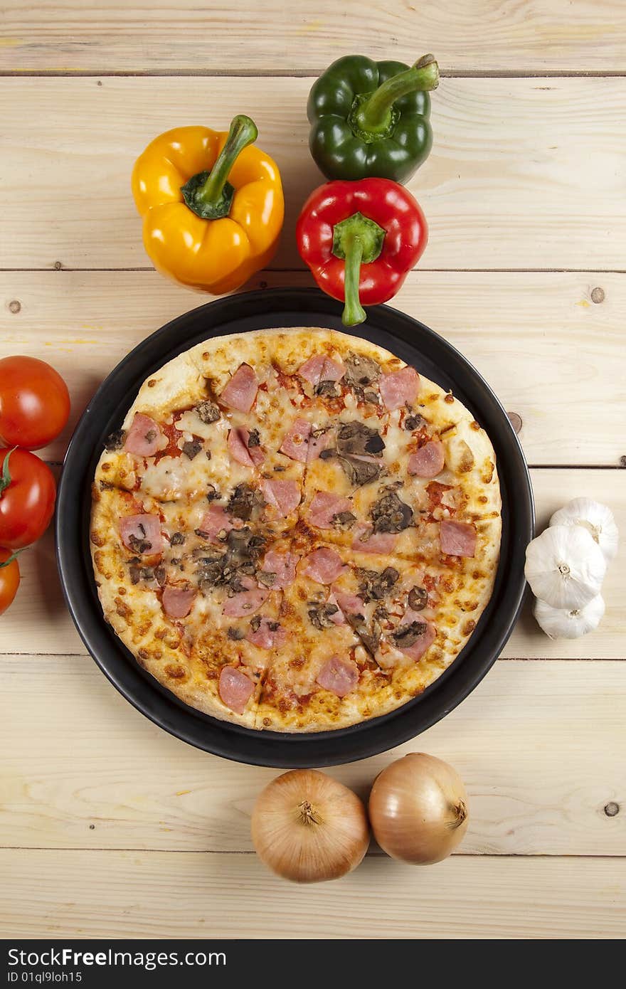 A couple of delicious pizzas, with raw tomatoes, green peppers and mushrooms. A couple of delicious pizzas, with raw tomatoes, green peppers and mushrooms