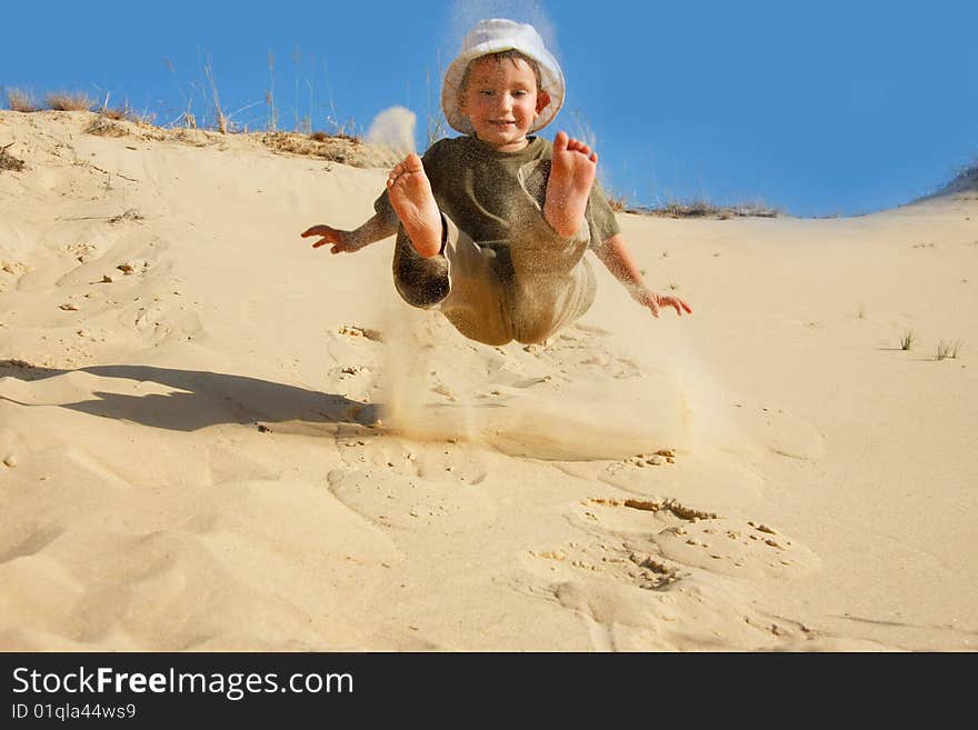 Boy jumping in sands