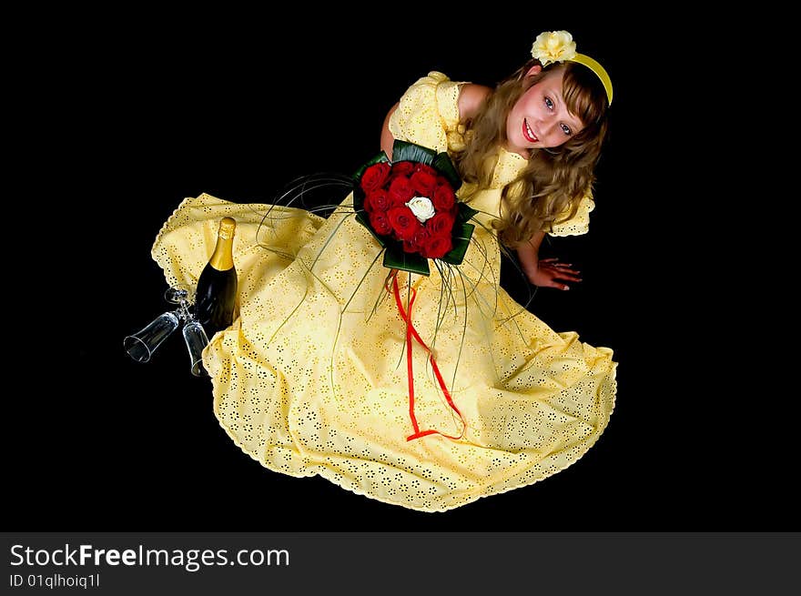 Portrait of a beautiful young bride showing her wedding bouquet of red and white roses on black background, studio shot. Portrait of a beautiful young bride showing her wedding bouquet of red and white roses on black background, studio shot