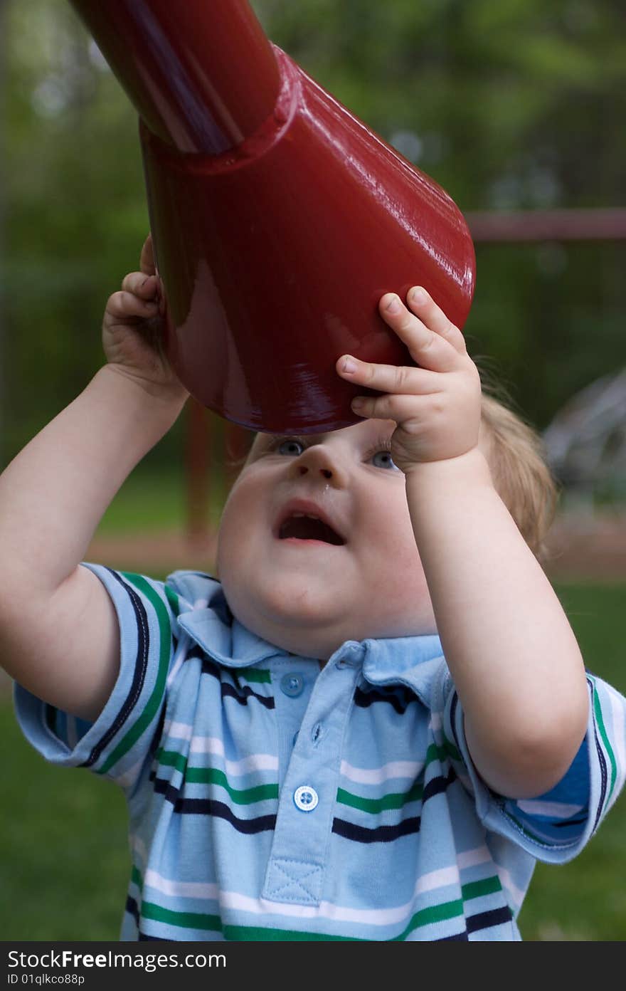 Cute Blue-Eyed Boy Playing with Mega Phone at Playground. Cute Blue-Eyed Boy Playing with Mega Phone at Playground