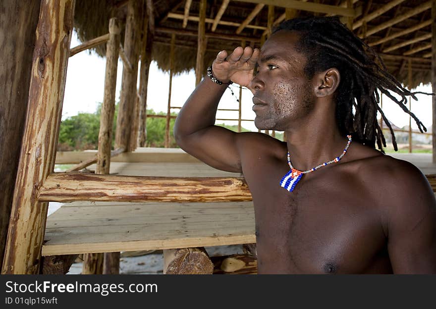 Black man watching away under wood umbrella. Black man watching away under wood umbrella